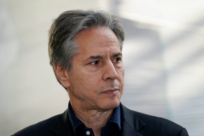 U.S. Secretary of State Antony Blinken listens as U.S. Secretary of Defense Lloyd Austin speaks with reporters after returning from their trip to Kyiv and meeting with Ukrainian President Volodymyr Zelenskiy, near the Polish-Ukrainian border