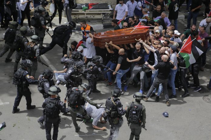 Israeli police carry the casket of Shireen Abu Akleh