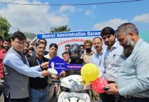 DC Baramulla distributes 27 retrofitted motorized tricycles among specially-abled